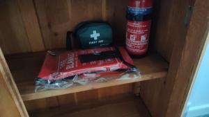 a shelf with a bag of food and a fire extinguisher at Fair Oak Self-Catering Accomodation in Sandown