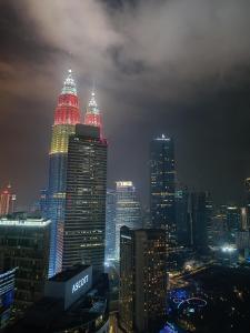 a city skyline at night with lit up buildings at Soho Suites KLCC by LX Suites 2 in Kuala Lumpur