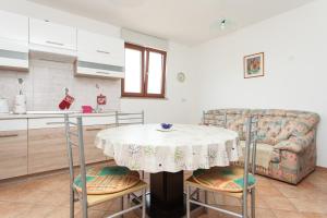 a kitchen with a table and a couch at House Soni - 800 m from the sea in Rovinj +14 photos