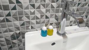 a bathroom sink with two bottles on top of it at Bujak Permai Villa Matahari Lombok NTB in Praya