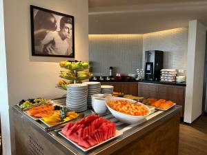 a buffet with fruits and vegetables on a table at Atlantic Ocean Residence in Fortaleza