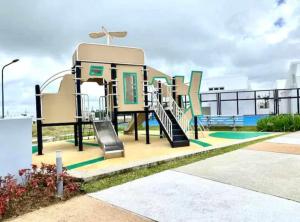 a playground on the roof of a building at Cozy Holiday Home at Batulao Artscapes 2Br brand new fully airconditioned in Calo