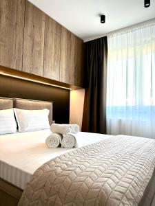 a hotel room with a bed with towels on it at 4friendscoresibrasov M&L in Braşov