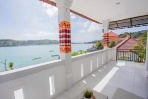 uma varanda com vista para a água em The Waterfront Beach House em Nusa Lembongan