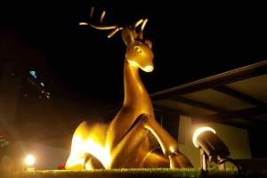 a statue of a gazelle sitting down at night at Rusa Cottage (Sleeps 10 pax - 1 min walk from KSL) in Johor Bahru