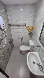a bathroom with a white toilet and a sink at Rusa Cottage (Sleeps 10 pax - 1 min walk from KSL) in Johor Bahru