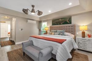 a bedroom with a large bed and a chair at Awesome Location with Dock, Pool, Bicycles & Kayaks in Cape Coral