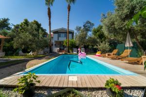 a swimming pool with a girl in the water at Z Villa in Pırnaz