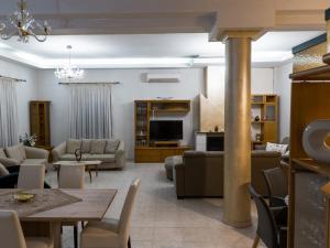 a living room with a couch and a table at MG Villa Rhodes in Kalithies