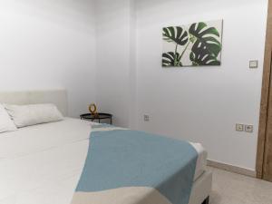a bedroom with a bed and a painting on the wall at MG Villa Rhodes in Kalithies +47 photos