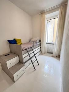 a small bedroom with a bunk bed and a window at Splendid Lake 3 in Desenzano del Garda