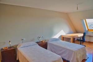 Habitación hospitalaria con 2 camas y mesa en Illas Atlánticas, en Ribeira