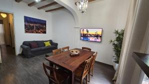 a dining room with a table and a couch at Romantic apartment in the center of Barcelona in Barcelona