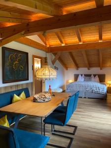 a dining room with a large wooden table and a bed at Ferienwohnungen Jägerheim & Jägerhaus in Ehrwald