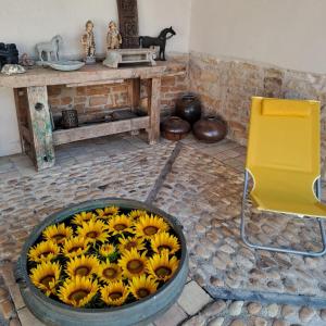 a large tub filled with sunflowers in a room at Chambres d hotes proche Macon in Grièges