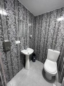 a bathroom with a toilet and a sink at Otel NİL FIRAT in Bursa