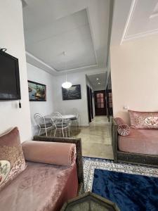 a living room with two couches and a dining room at apartment on the beach in El Harhoura