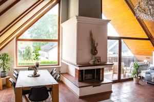 a living room with a table and a fireplace at Gemütliche Galerie-Wohnung in Biberach in Biberach an der Riß