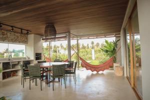 a dining room with a table and chairs at Casa Seriguela - Praia do Patacho - Rota Ecológica dos Milagres in Pôrto de Pedras