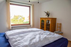 1 dormitorio con cama y ventana en Gemütliche Galerie-Wohnung in Biberach, en Biberach an der Riß