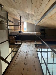 a room with bunk beds and a wooden floor at Lillahuset i Helsingborg! in Helsingborg