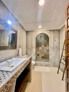 a bathroom with a sink and a toilet at Riad Al Wafaa in Marrakesh