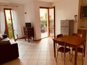 a living room with a table and a refrigerator at LaMonica.House in Salò
