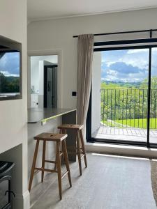 a kitchen with a table and a large window at The Loft Studio apartment - above detached new build garage in Llanymynech