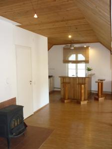 an empty living room with a wood stove in it at Marigolds in Sigulda