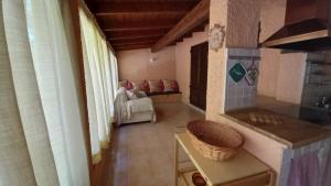a room with a kitchen and a living room at Calaverde Pula Il Giardino di Alessandra in Fort Village +15 photos