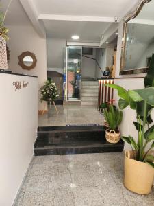 a lobby with stairs and potted plants at Hostal Cuevas in Fuengirola