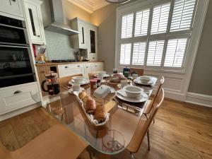 a kitchen with a glass table with food on it at The Brontë Wing at The Apothecary Rye in Rye