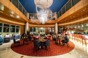 a lobby with people sitting at tables in a restaurant at Bay Lake Tower at Disney's Contemporary Resort in Orlando