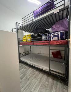 um quarto com três beliches num quarto em APPARTEMENT PIED DES PISTES SUPER SAUZE em Enchastrayes