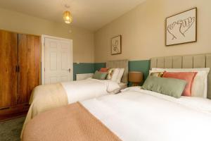 a bedroom with two beds and a door at Clock Tower Retreat - Sea View Apartments in Morecambe in Morecambe