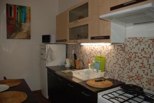 a small kitchen with a sink and a stove at Apartment Vlhka in Brno