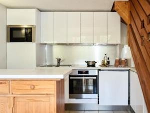 a kitchen with white cabinets and a stove at Appartement Montgenèvre, 4 pièces, 8 personnes - FR-1-266-129 in Montgenèvre