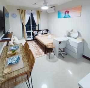 a bedroom with a bed and a desk and a table at Z's Place in Suba