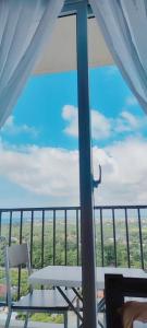 a balcony with two chairs and a view of the field at Z's Place in Suba