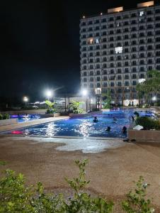 a large pool with people swimming in it at night at Z's Place in Suba