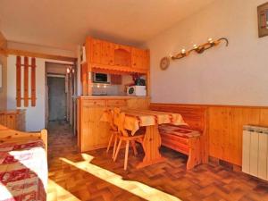 a kitchen with wooden cabinets and a wooden table at Studio Montvalezan-La Rosière, 1 pièce, 4 personnes - FR-1-398-570 in La Rosière