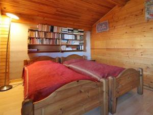 a bedroom with a bed with a red blanket on it at Chalet Montvalezan-La Rosière, 9 pièces, 18 personnes - FR-1-398-582 in Montvalezan