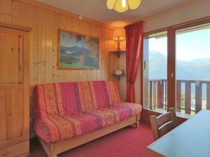 a bedroom with a bed and a balcony with mountains at Studio Montvalezan-La Rosière, 1 pièce, 4 personnes - FR-1-398-574 in La Rosière