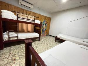 a room with two bunk beds and a chalkboard at Casa Hostal Luna Llena in Cartagena de Indias