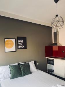 a bedroom with a bed and two pictures on the wall at Rainbow Suites Thessaloniki in Thessaloniki