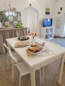 una mesa blanca con un tazón de comida. en Casa DiLù en Sannicola