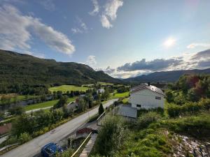 an aerial view of a road with a house and mountains at Private Room With Beautiful View in Vassenden