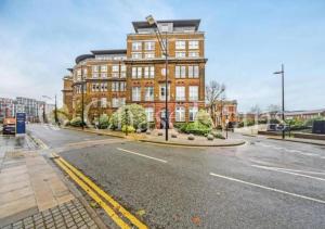 a large brick building on a city street at Your Riverside Home in Woolwich