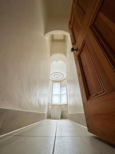 an empty hallway with a door and a window at Beautiful Grade II listed apartment. in Leek