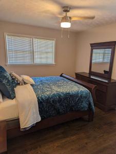 a bedroom with a bed and a dresser and a mirror at Home away from home in Marietta